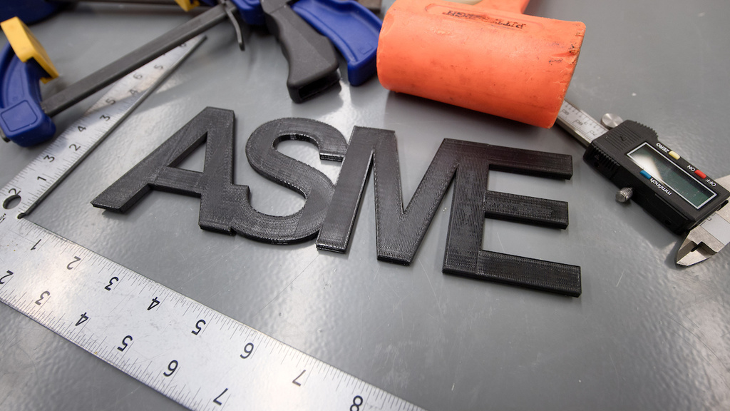 Tools surrounding letters spelling out ASME
